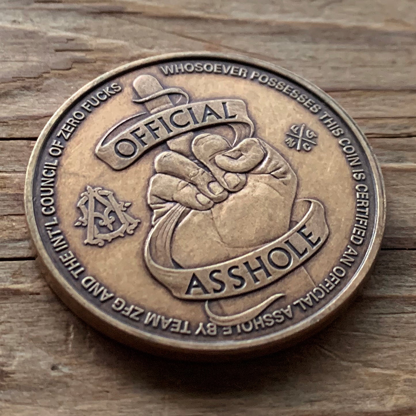Official Asshole Coin Back on Wood