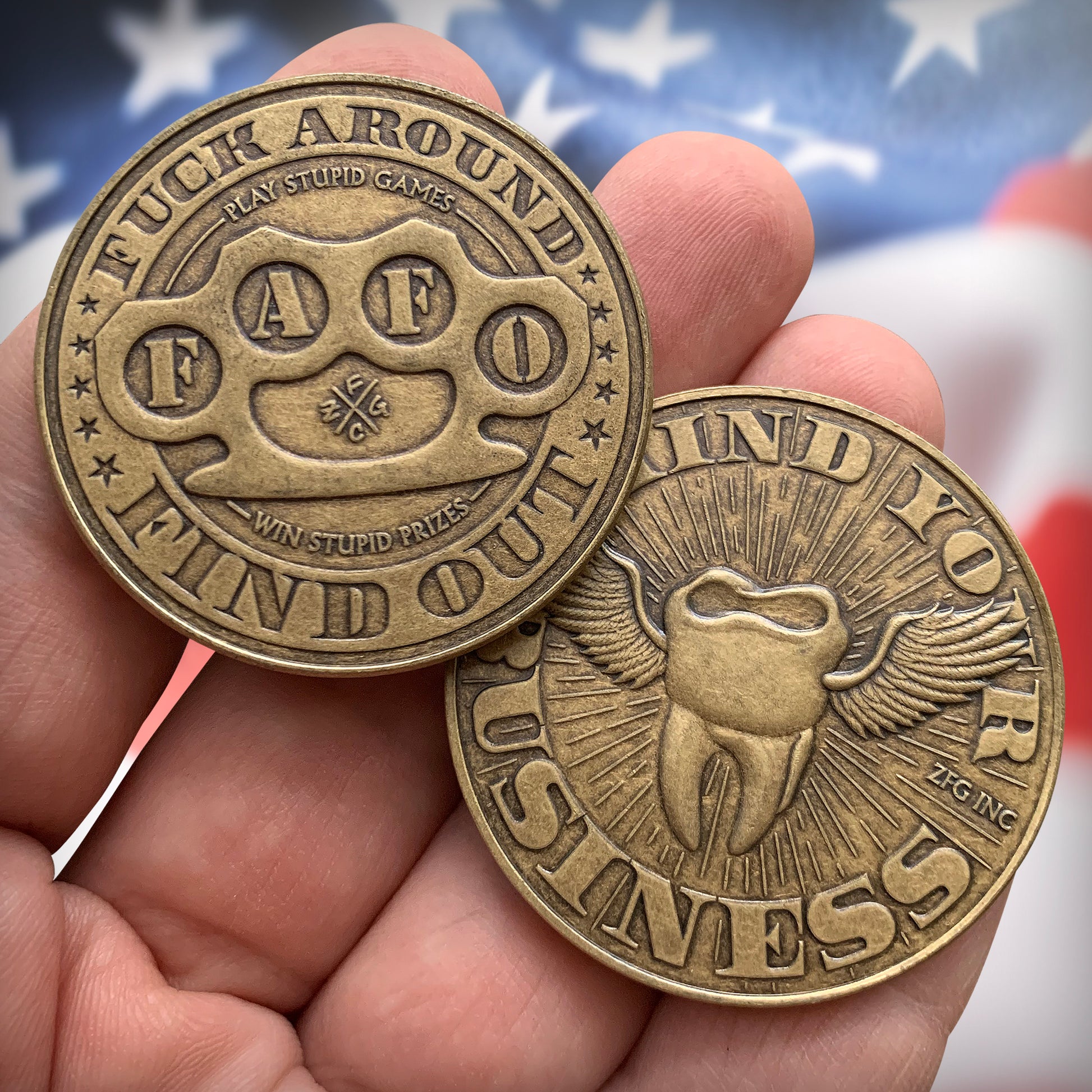2 coins in-hand in front of USA flag