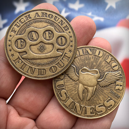 2 coins in-hand in front of USA flag
