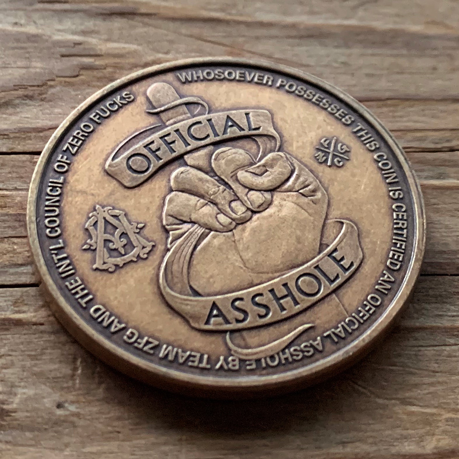 Official Asshole Coin Back on Wood
